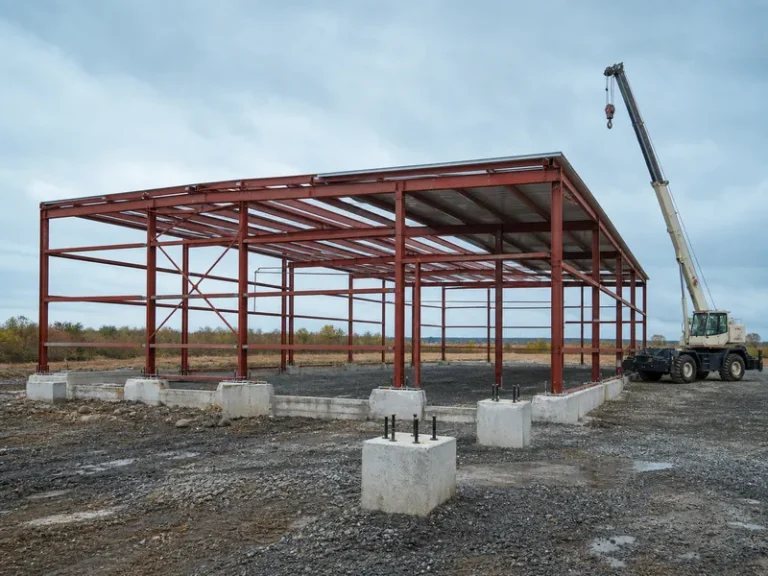 Steel building under construction with structural frame erected, the stage where building codes for steel buildings govern design criteria